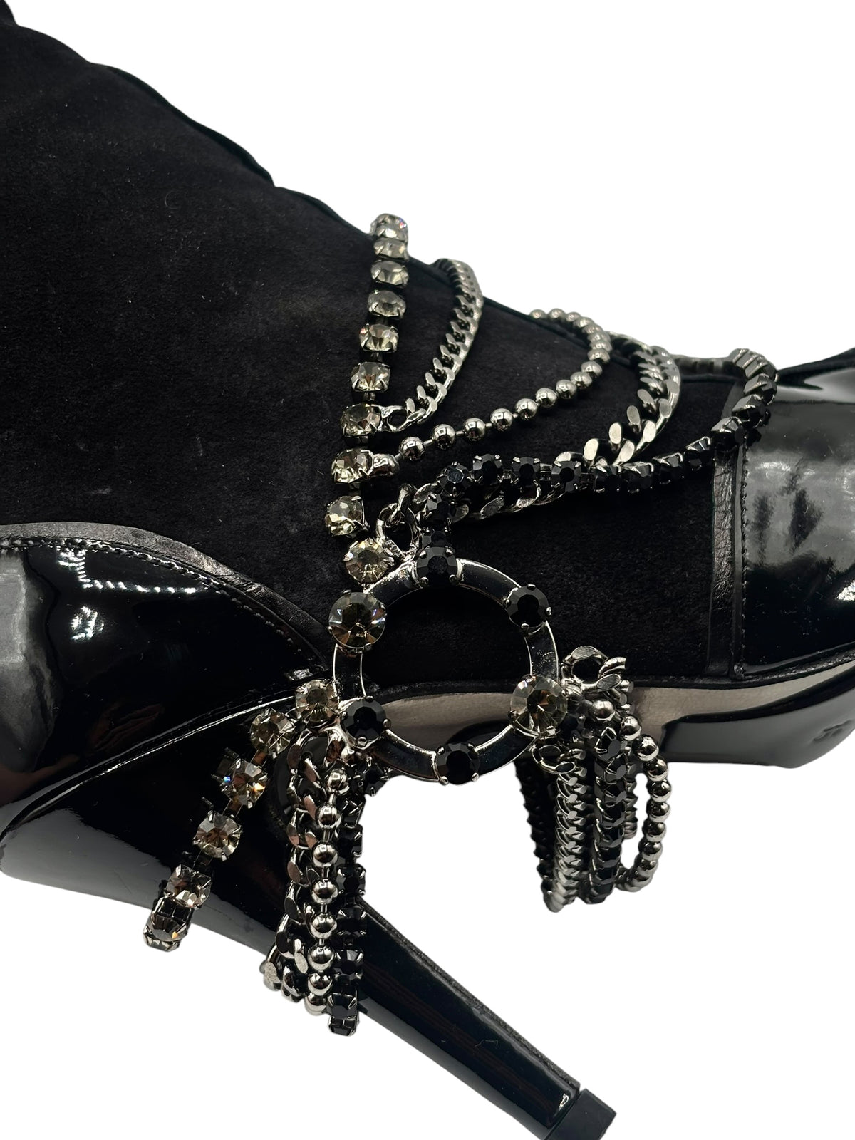 Close-up of black boot front with layered chain and jeweled strap details