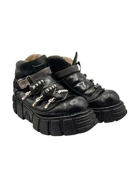 Black leather platform ankle boots with triple clasp straps and silver-tone studs