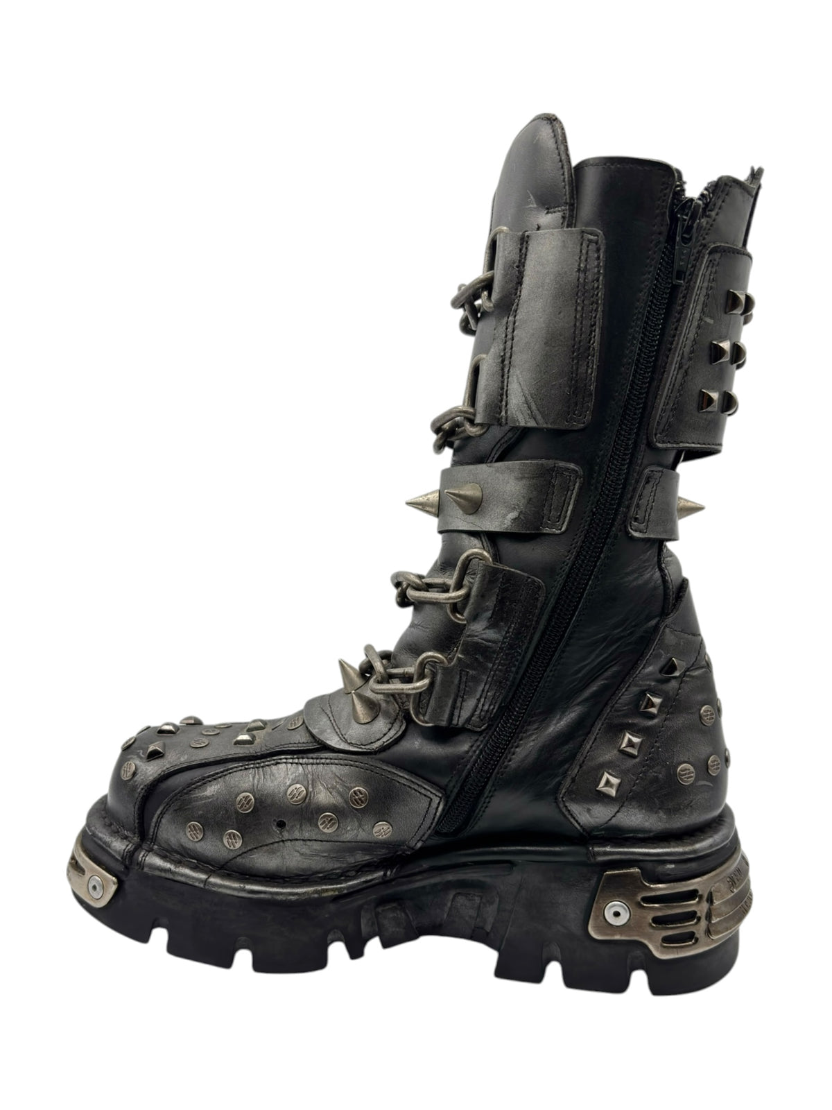 Vintage studded chain boots side 3/4 view with stacked buckles and spikes on toe