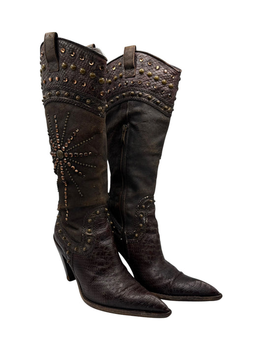 Brown knee-high cowboy boots with stacked heel, side stud details, and pointed toe