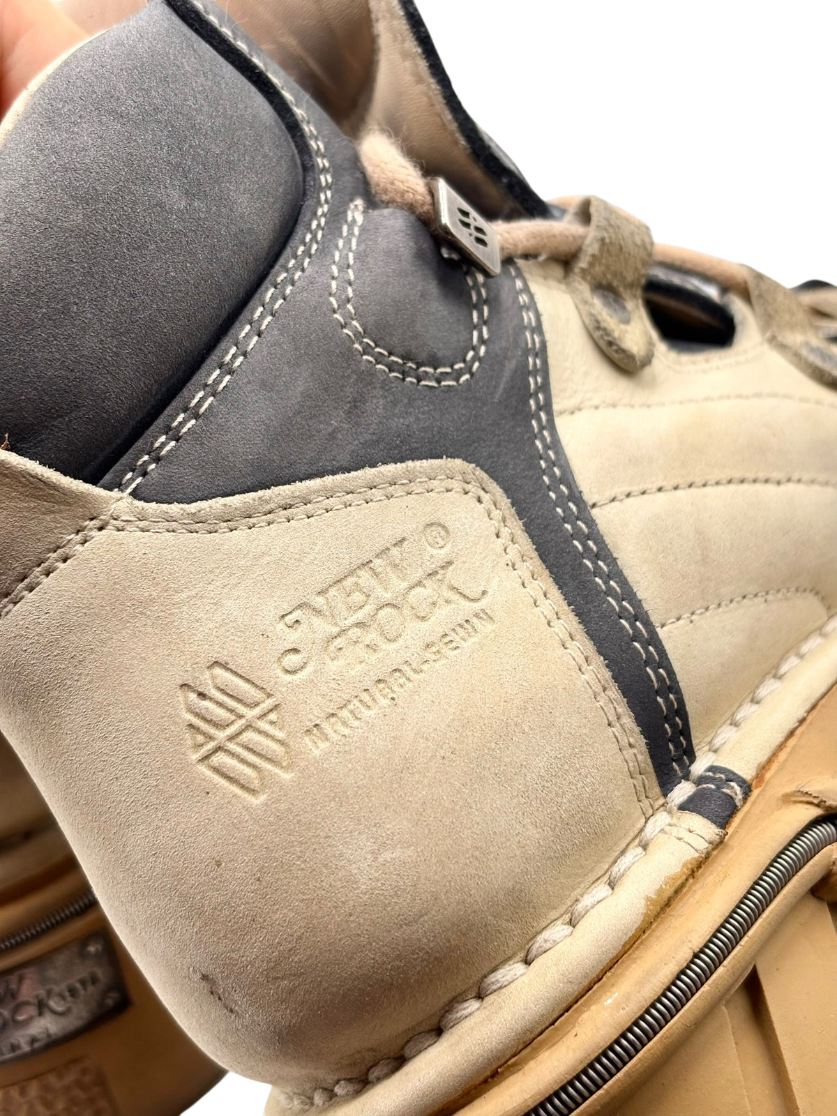 Close-up of beige and dark leather platform boot toe with embossed “NEW ROCK” patch