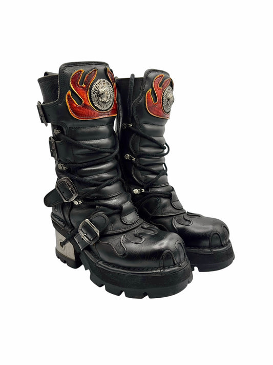 Mid-calf leather boots in black with orange flame-style patches and buckles
