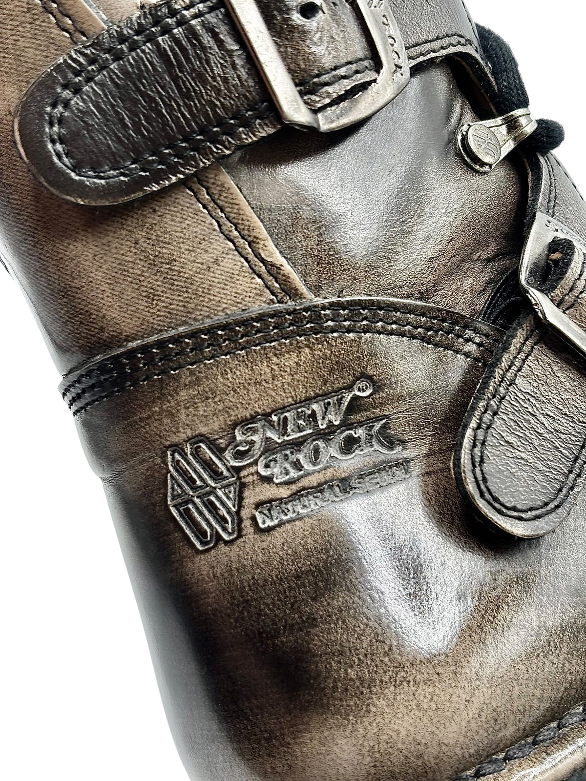 Close-up of New Rock logo patch on vintage leather boot with buckled strap