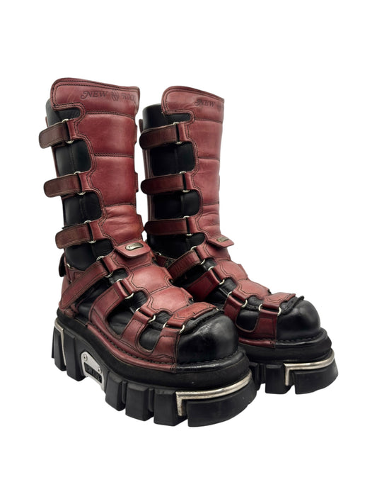 Knee-high platform boots in burgundy with multiple adjustable buckled straps and chunky tread