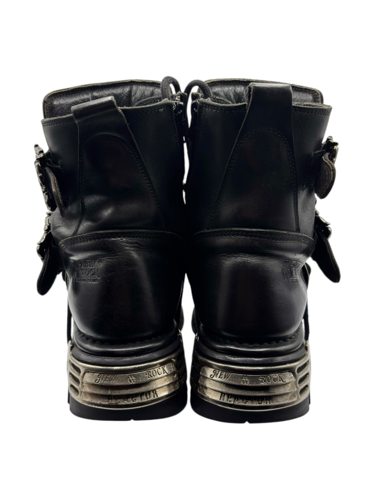 Black lace-up boots with ankle straps, chunky rubber sole, and silver heel trim