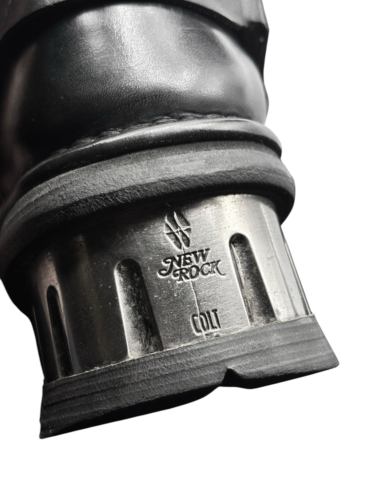Black boot heel and outsole with New Rock label on metal-look platform edge