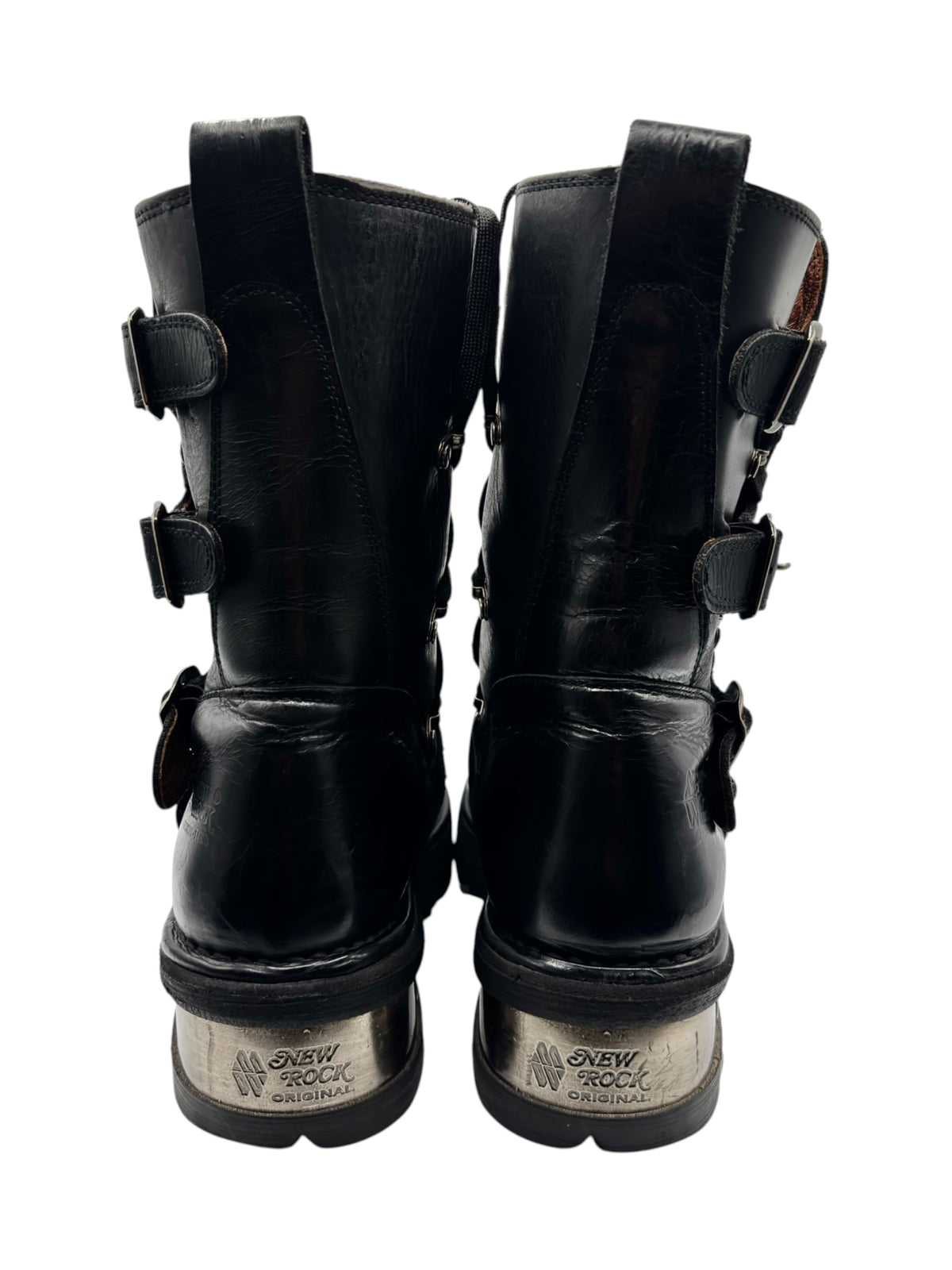 Black ankle boots with pull tabs, buckle straps, and platform tread sole