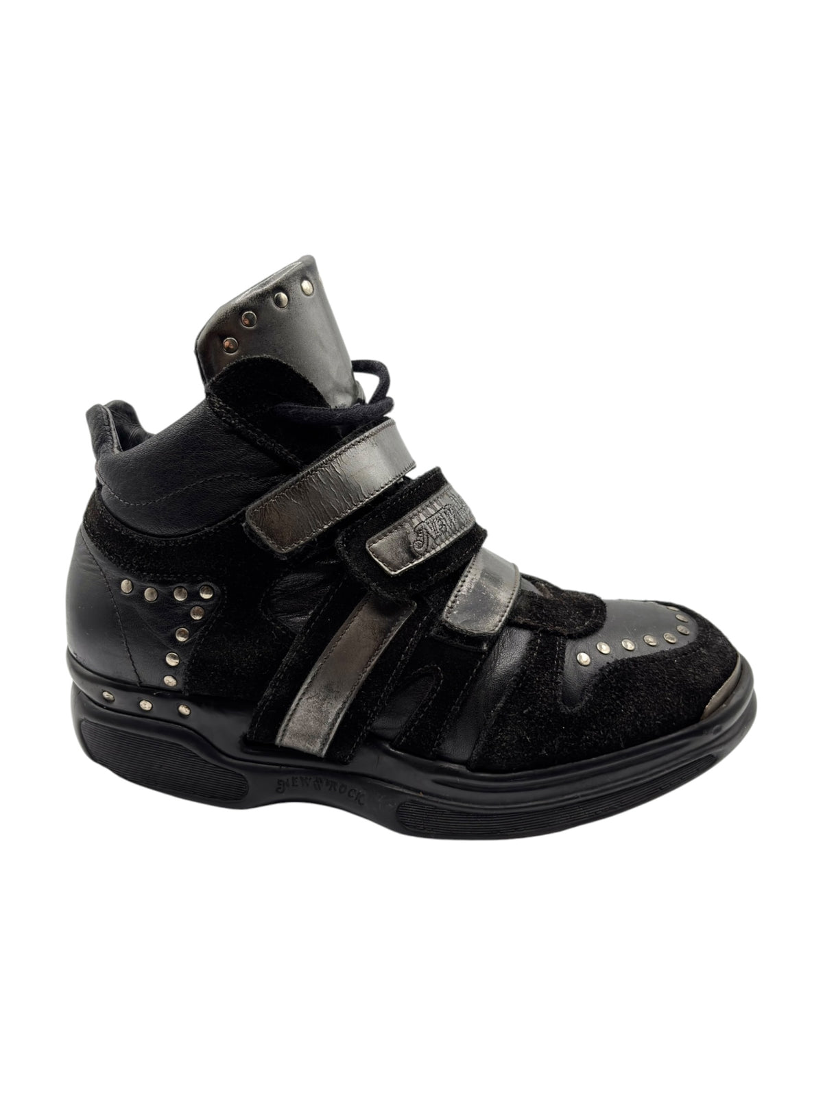 Black leather sneaker with double straps, side panel stitching, and stud trim