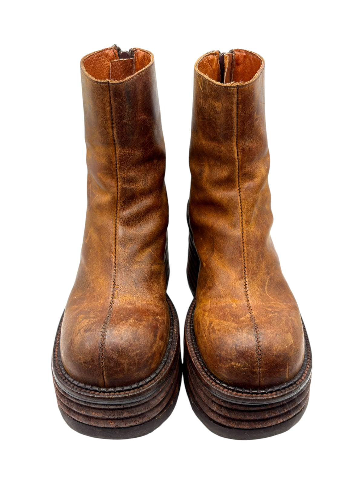 Brown leather ankle boots pair with side zippers and stacked heel platform