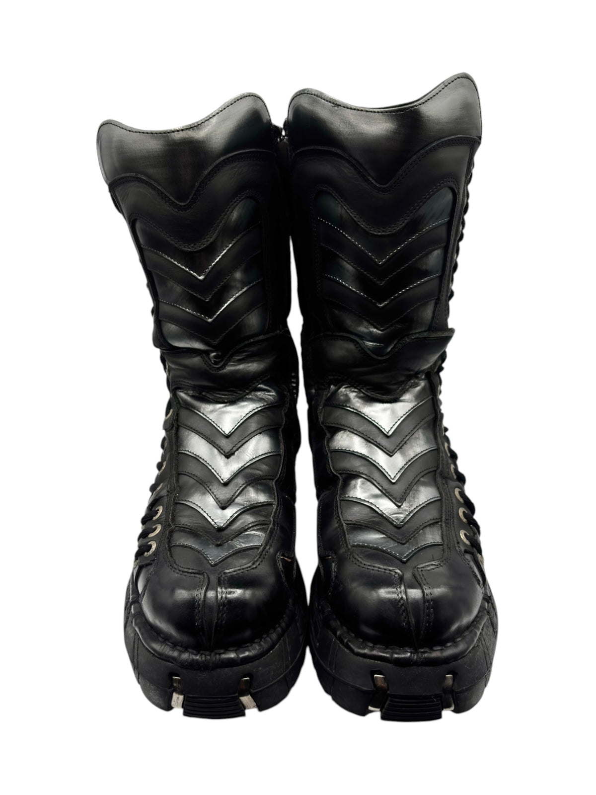 Black tall boots with chevron stitching on ankle panels and lace-up design