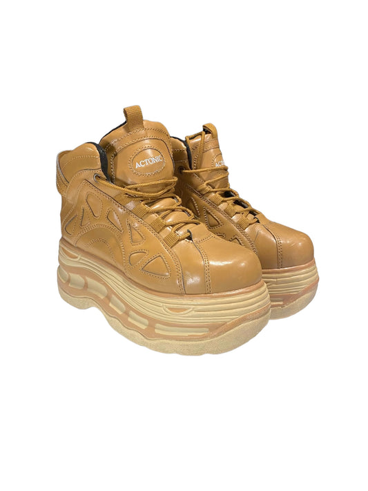 Tan leather lace-up platform boots with thick ridged sole and black inner lining.