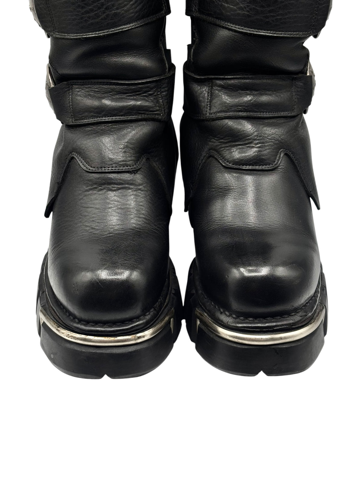 Pair of knee-high boots with black leather uppers and side strap buckles