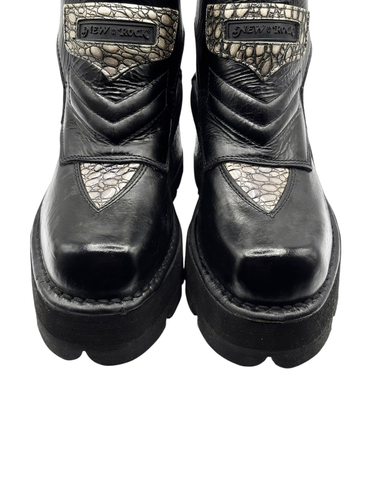 Black leather ankle platform boots with beige scale-pattern panels and side straps.