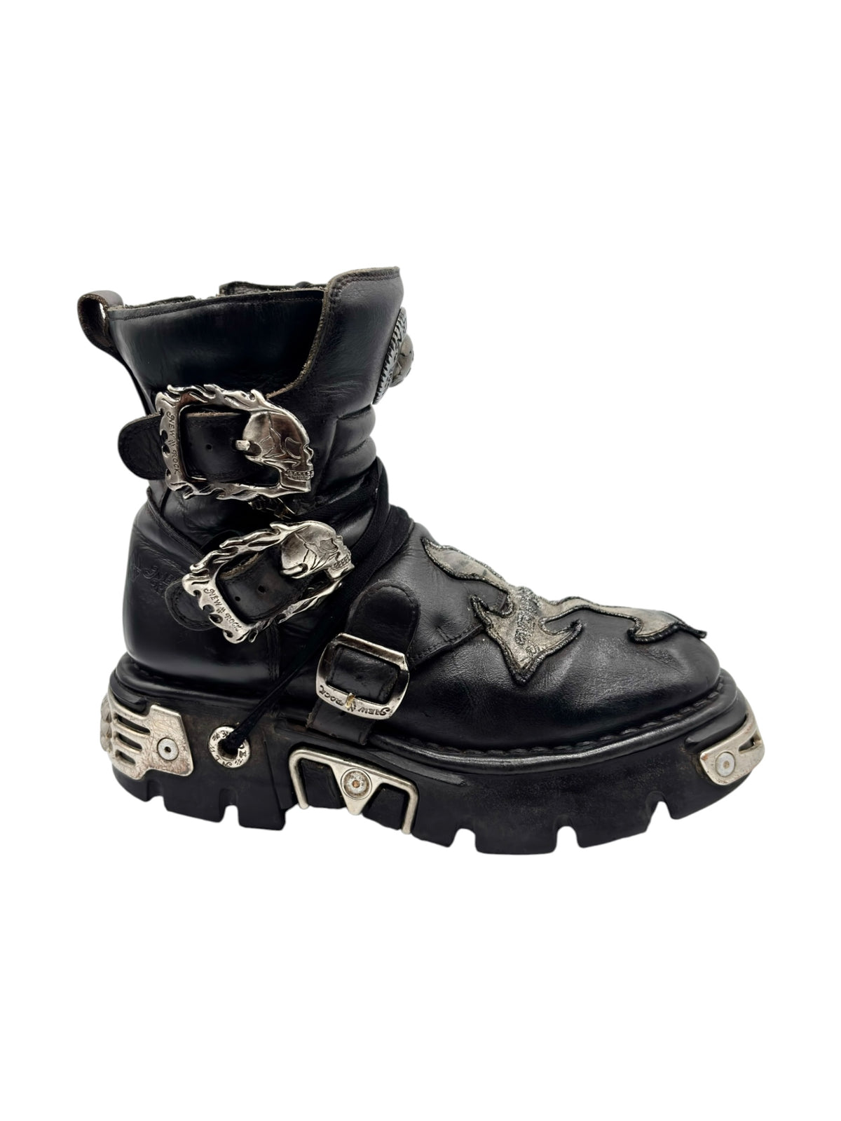 Black boots with decorative buckles, strap details, and raised tread sole