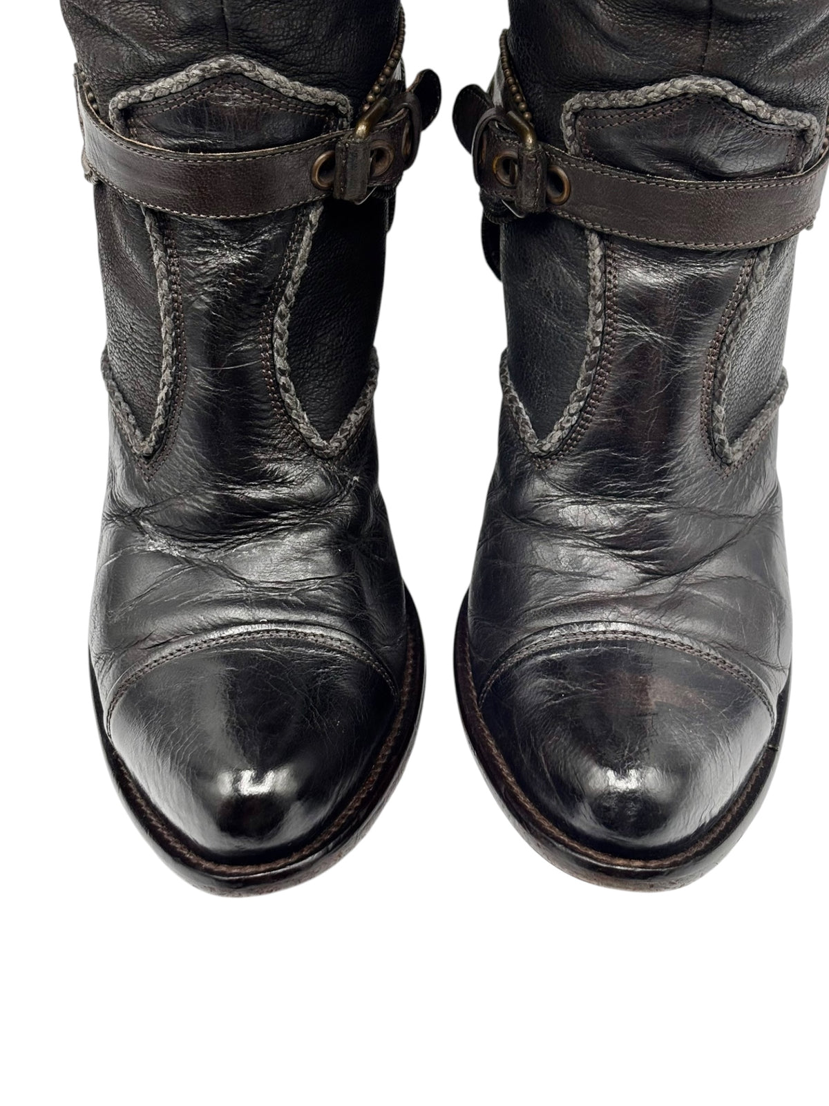 Knee-high leather boots with side buckles and embossed toe area