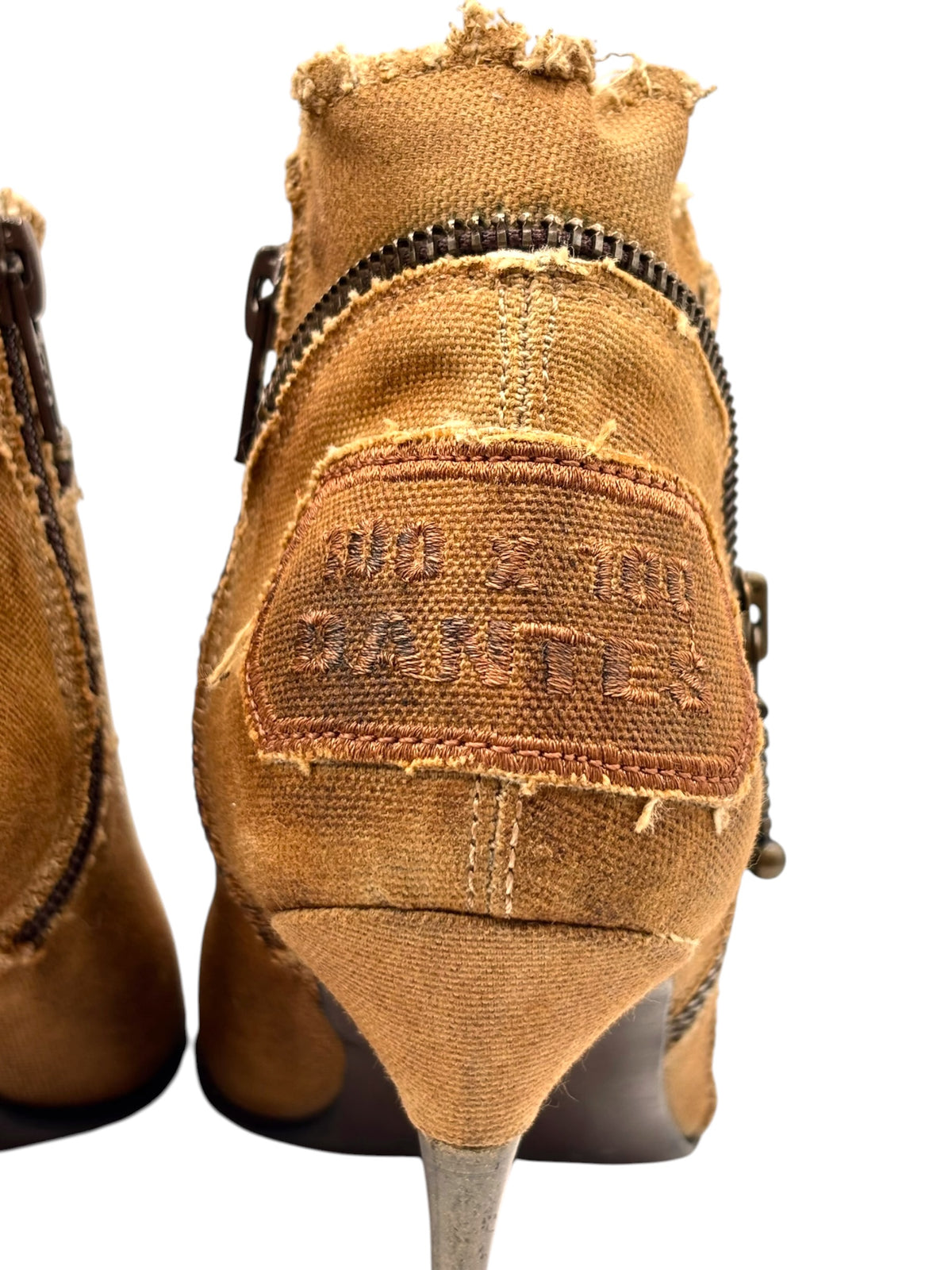 Rear view of tan ankle boots showing heel pull tab and stitched size label
