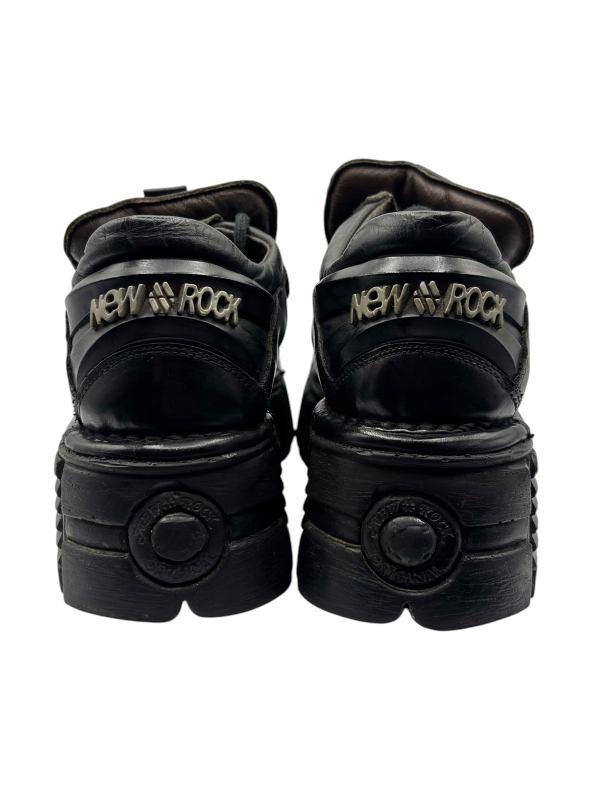 Vintage black platform boots with “New Rock” heel logo and rounded toe paneling.