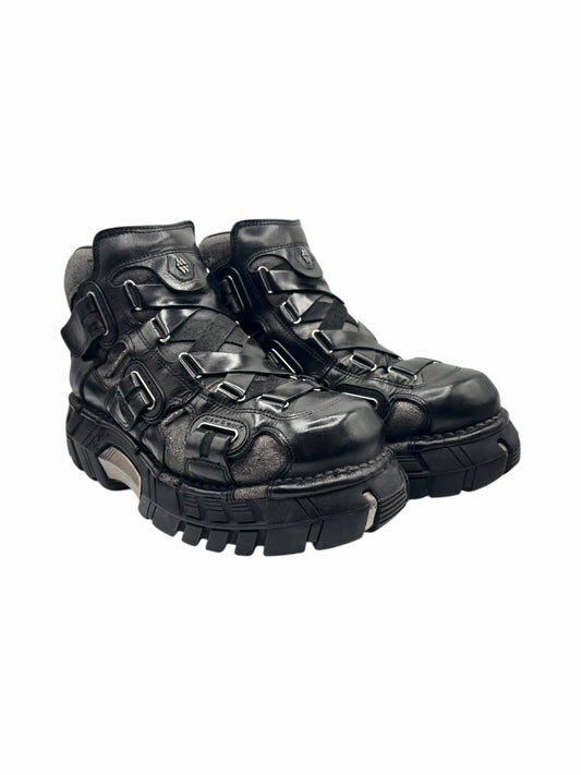 Black platform boots angled view with metal buckles and thick tread sole