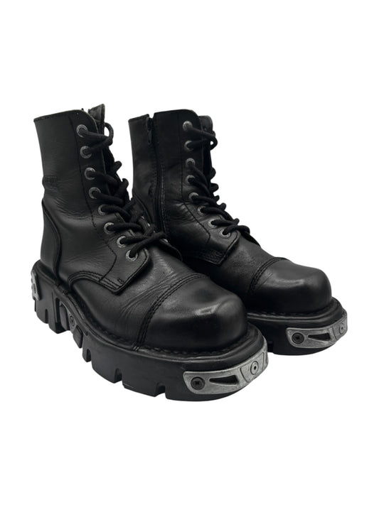 Black leather lace-up platform boots with chunky lug sole and metal heel plates
