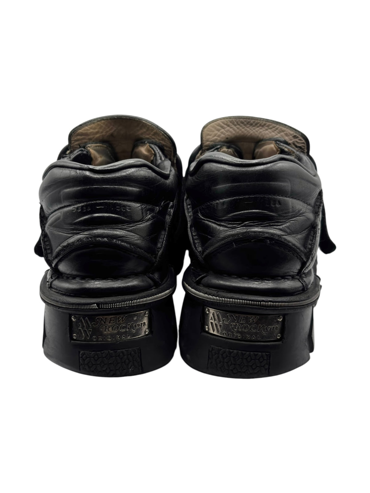 Back view of black leather platform boots with low heel caps and stitching