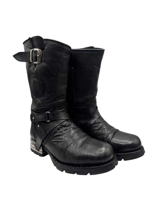 Black leather biker boots, side view with buckle strap and lugged tread sole