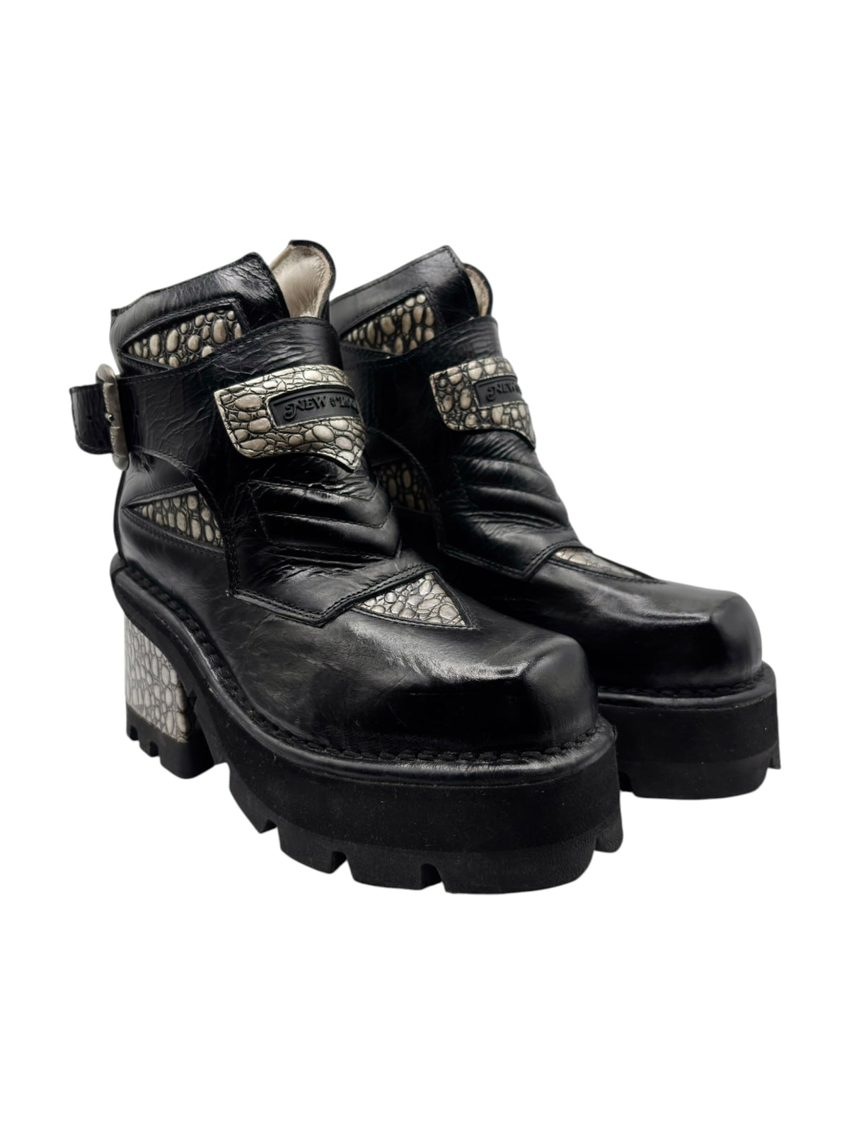 Black leather ankle boots with chunky platform heel and beige scale-pattern inset panels.