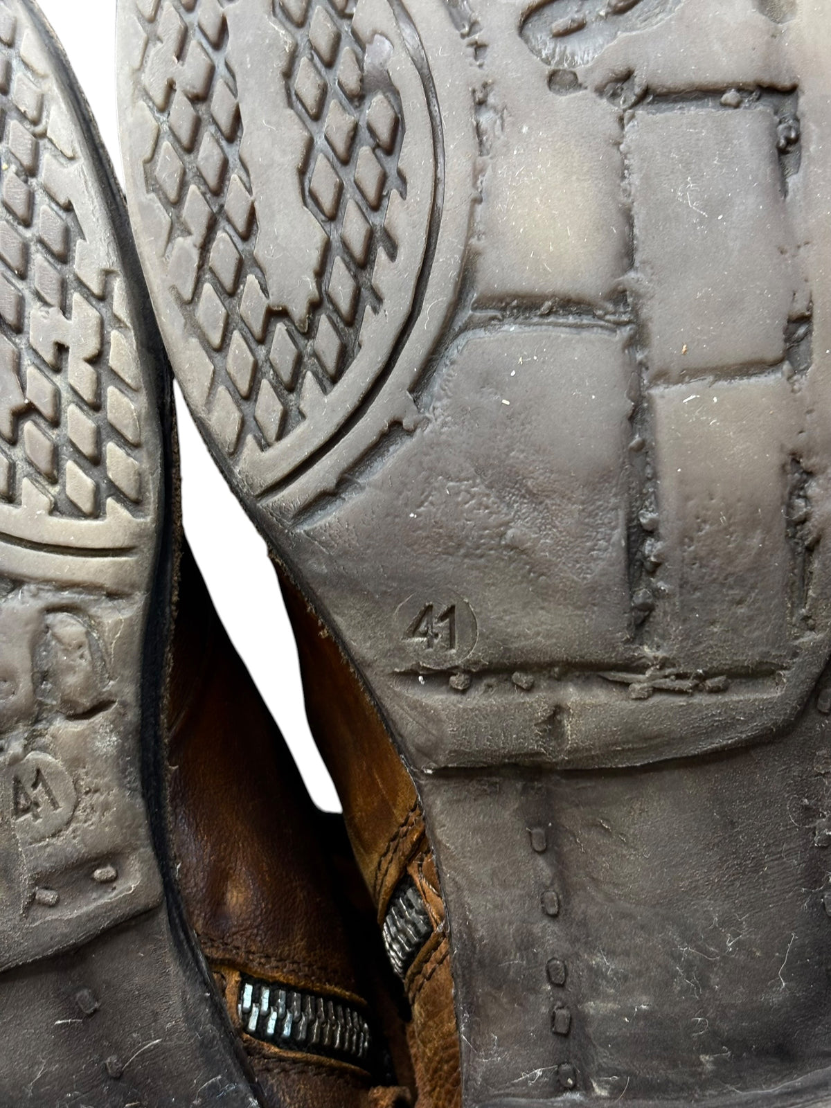 Brown leather boot outsole close-up with size marking 41 and tread blocks