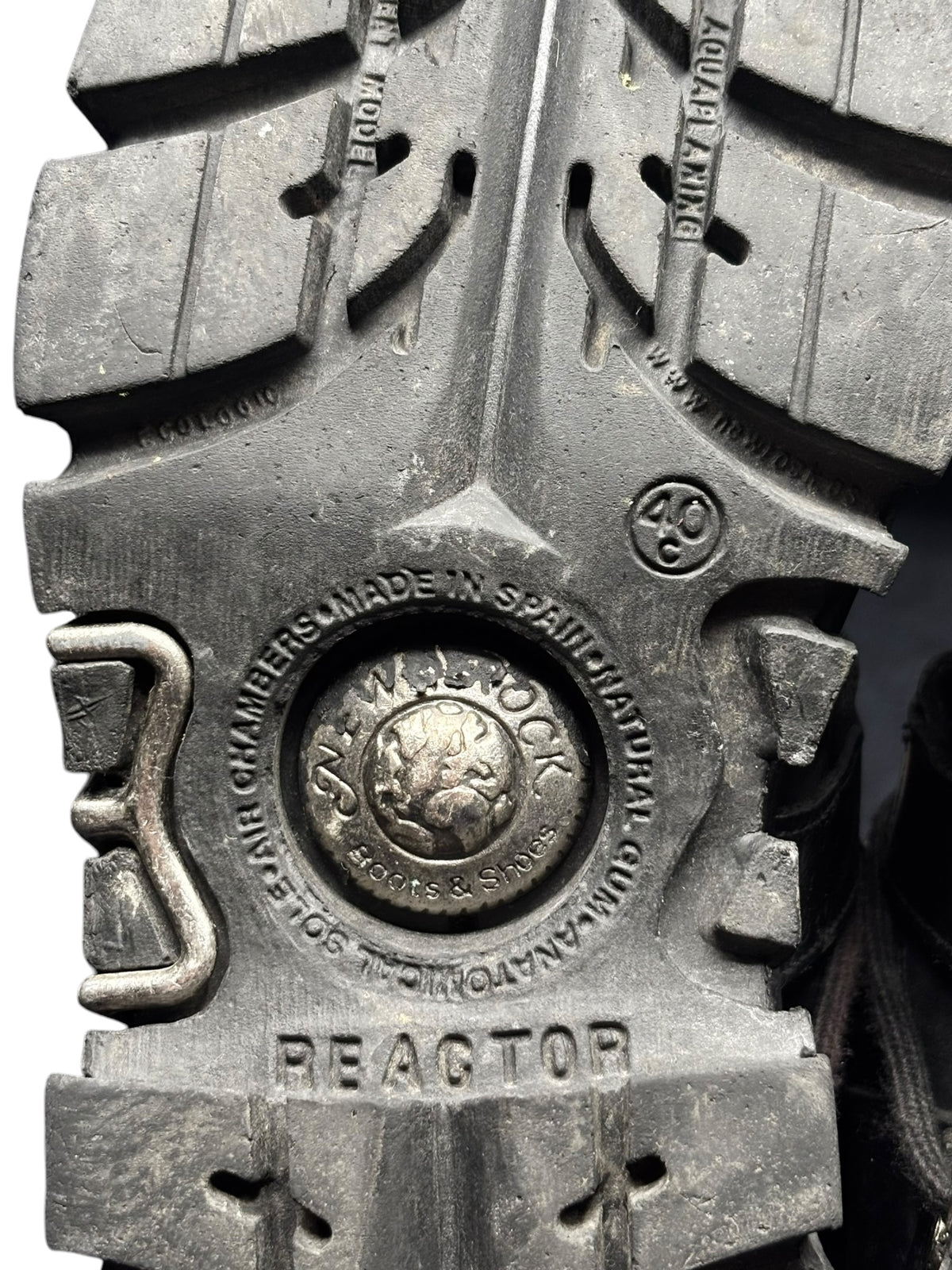 Black boot outsole with tread lugs and REACTOR stamp