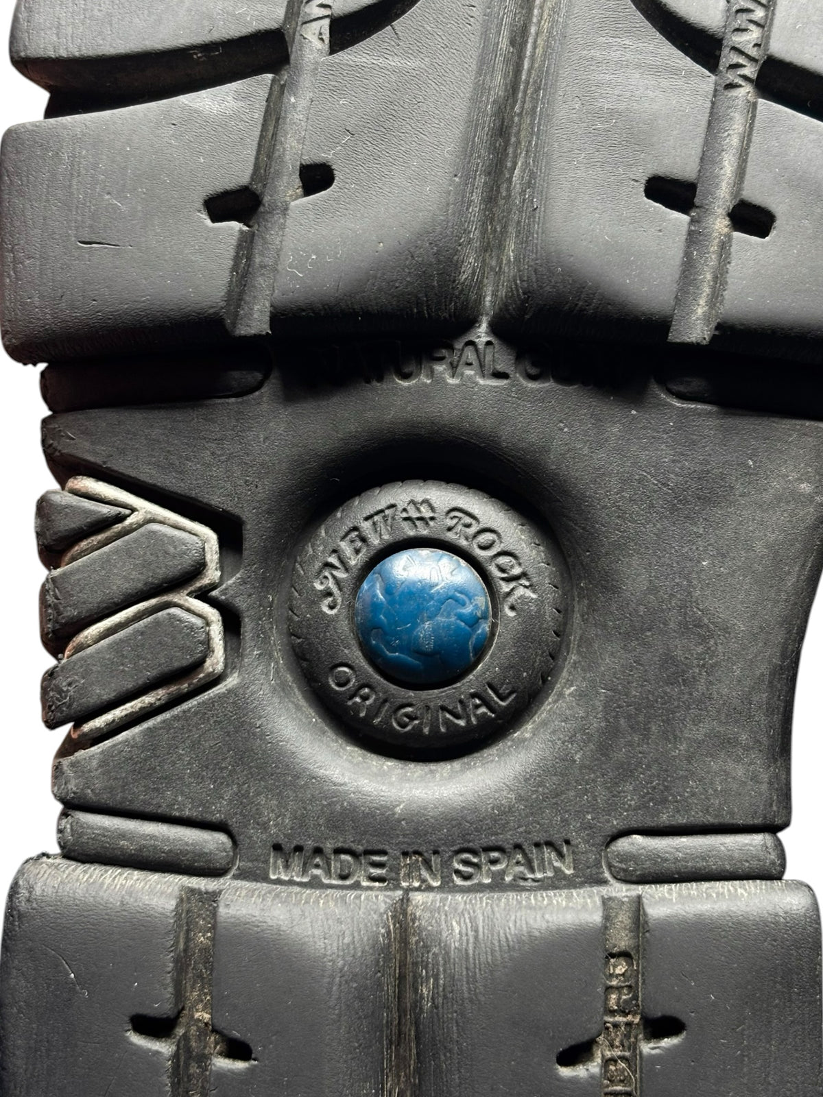 Studded chain platform boots, black outsole close-up with round logo and “Made in Spain”