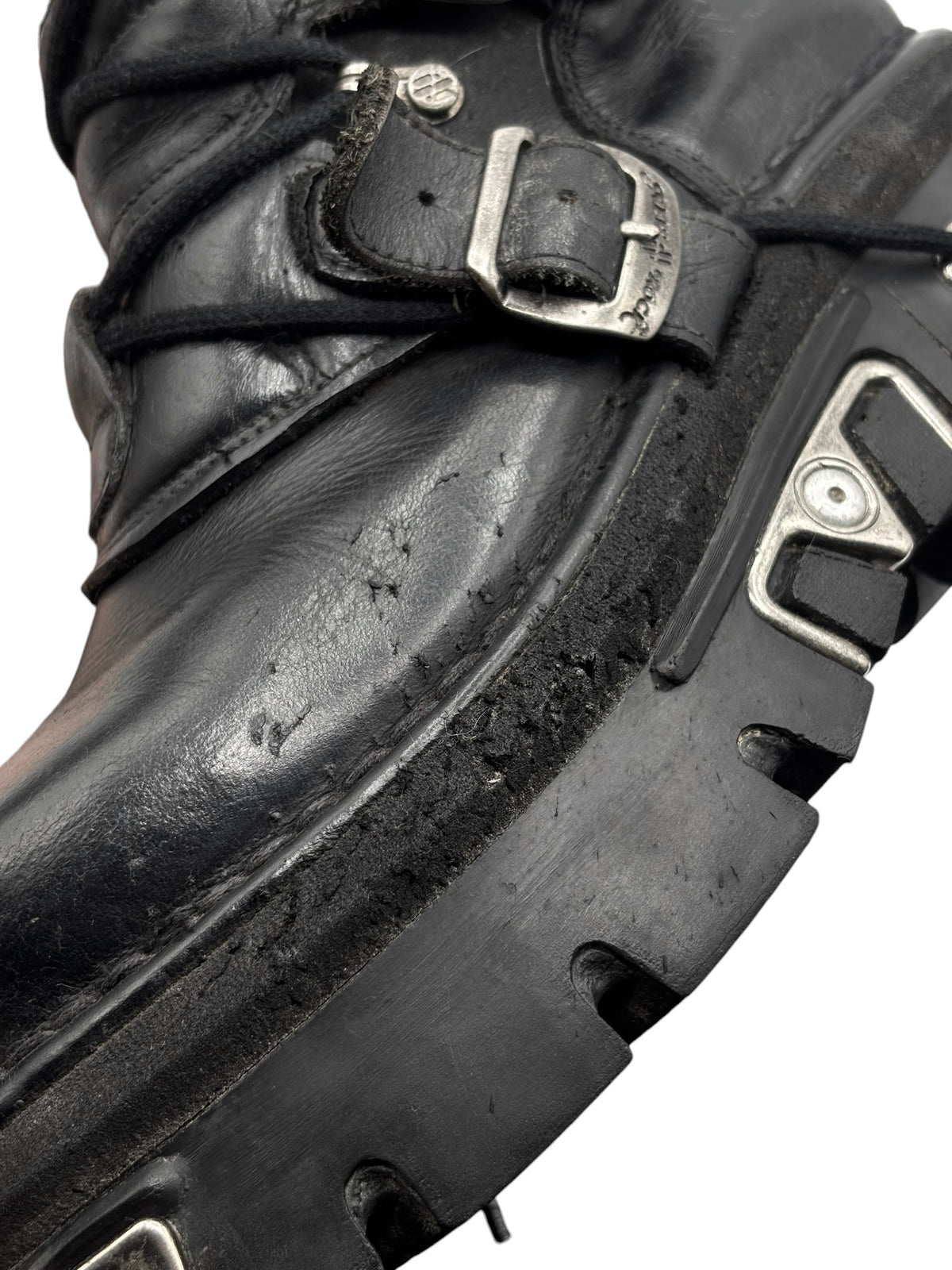 Black leather boot upper with metal buckle, strap, and stitched panel details