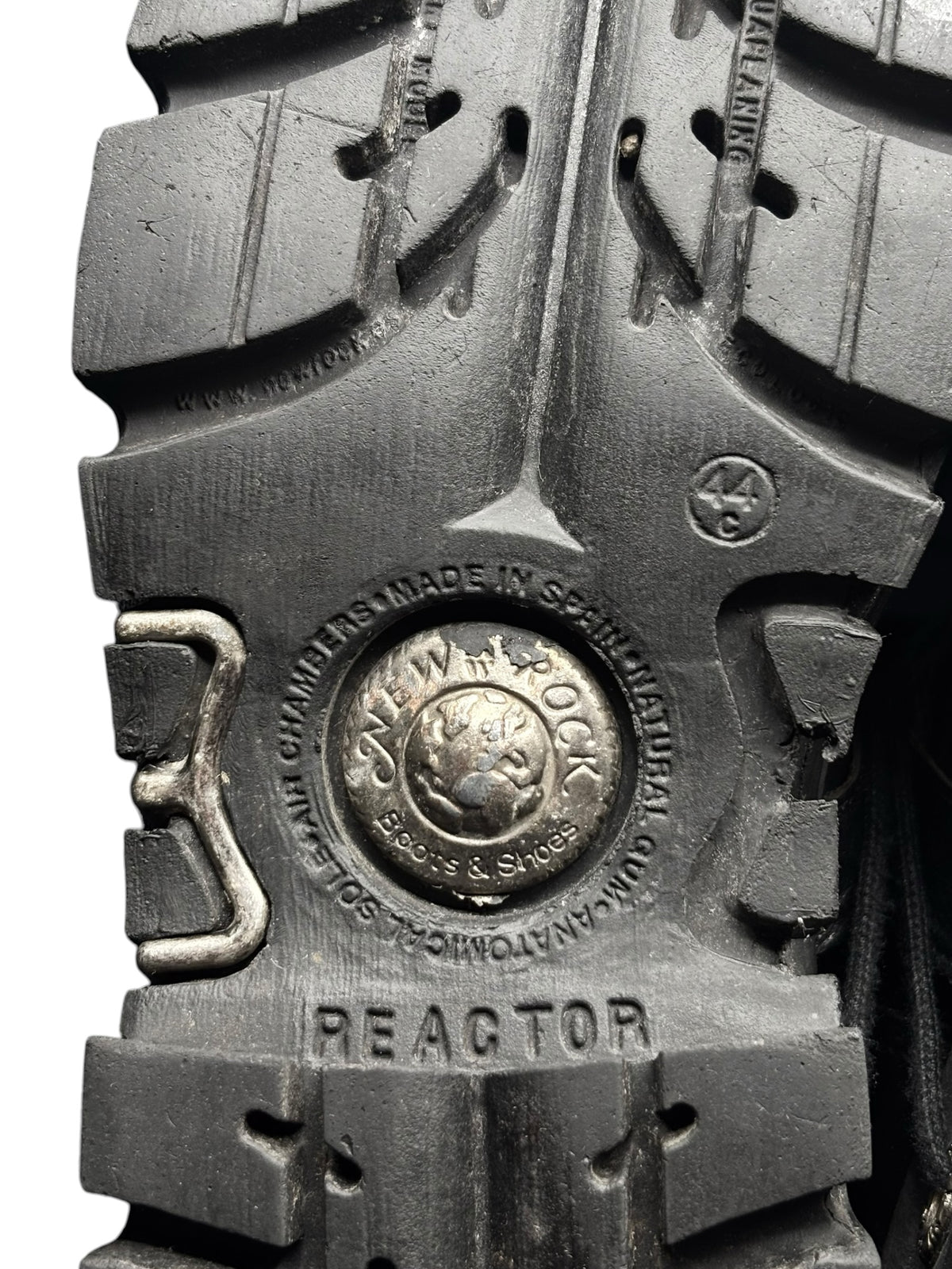 Mid-calf reactor boot outsole with metal “REACTOR” plate and stamped emblem