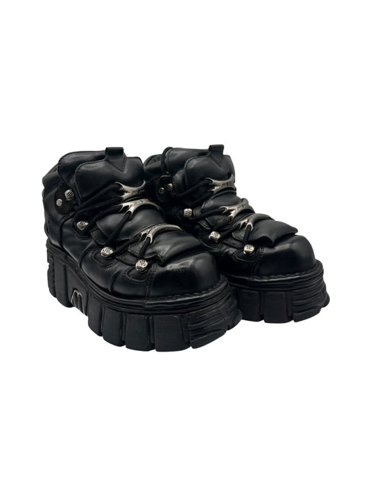 Black platform lace-up boots with thick tread and polished metal eyelets