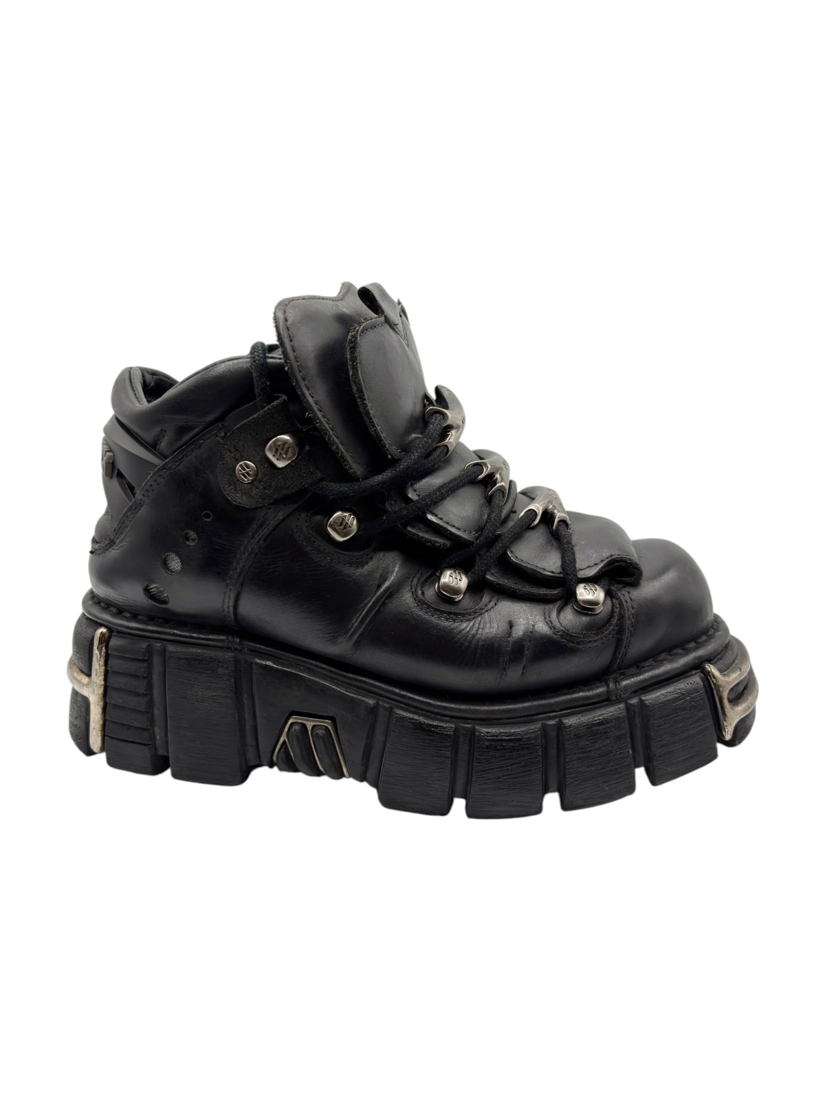 Black platform boot angled view with laces, strap accents, and chunky tread sole