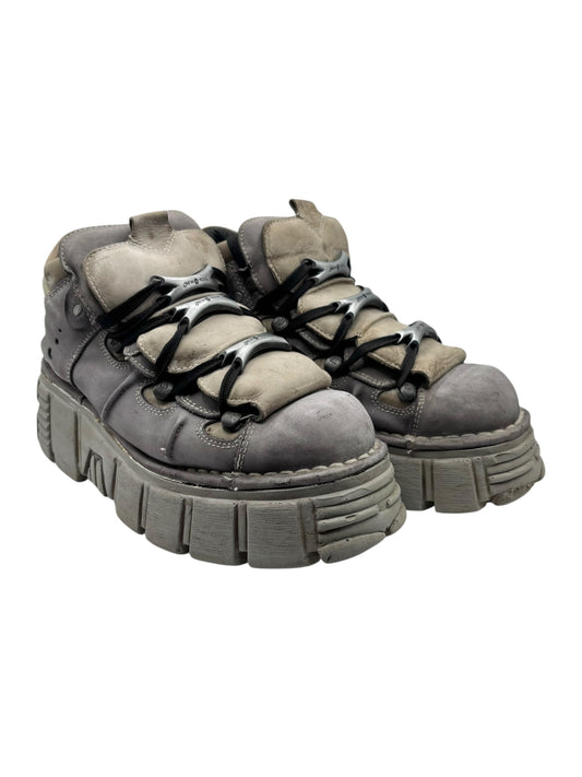 Grey platform boots pair view with black laces and thick platform sole