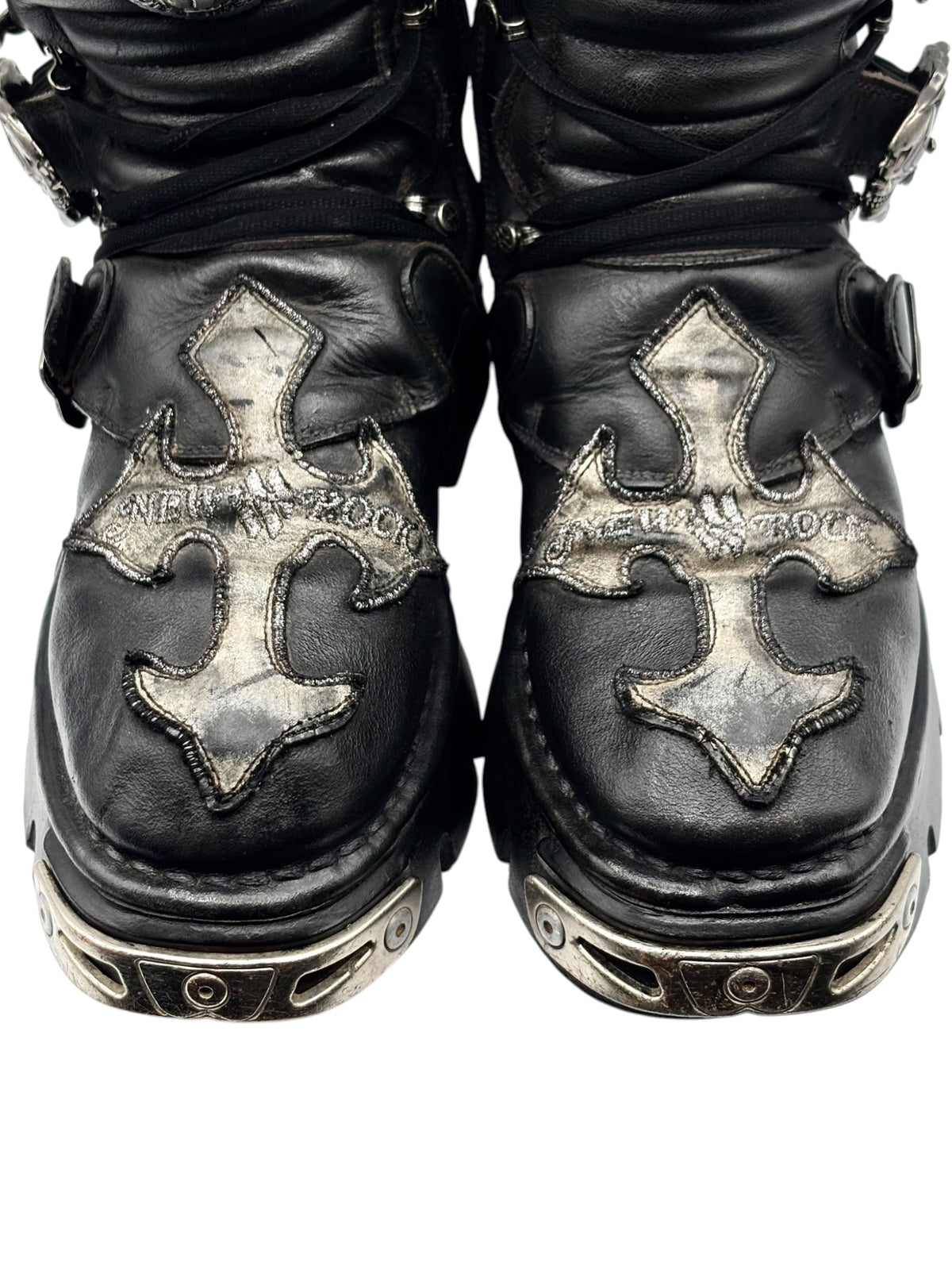 Black boots front view with metallic cross-stitch panels and chunky platform soles