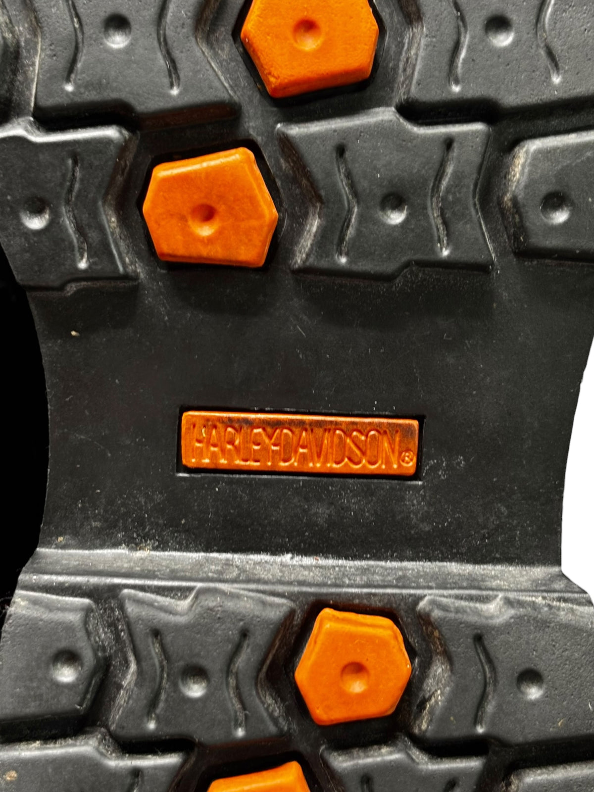 Rubber boot outsole tread with orange traction buttons and Harley-Davidson logo