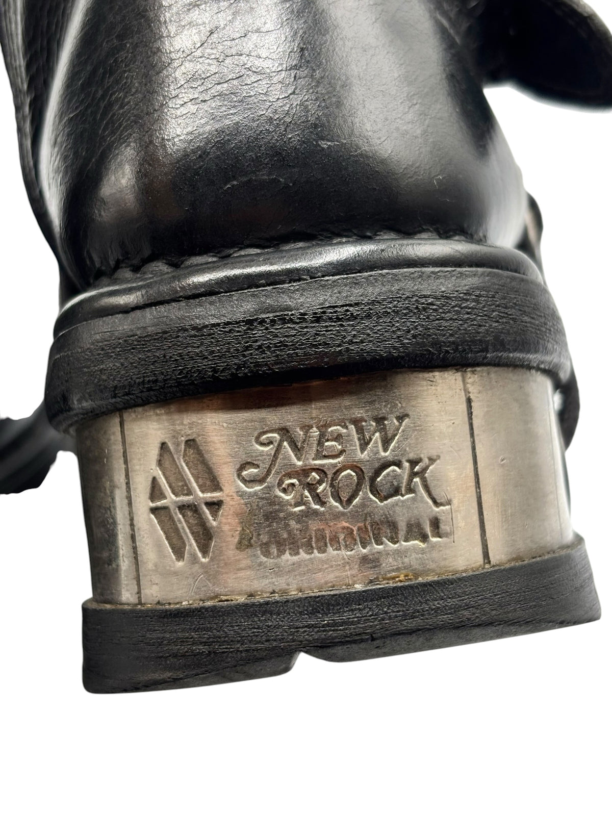 Boot heel with metal logo plate and textured rubber outsole