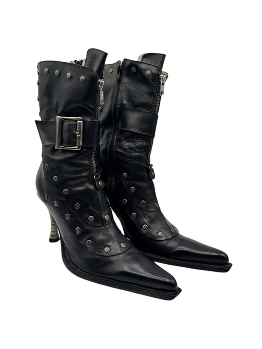 Side view of black studded high-heel boots with buckled strap and side zippers