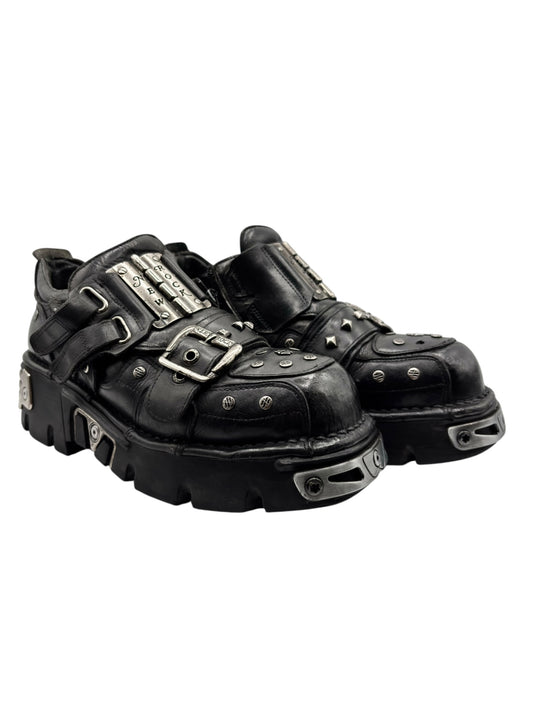 Black studded platform boots, side view with metal buckles and thick outsole