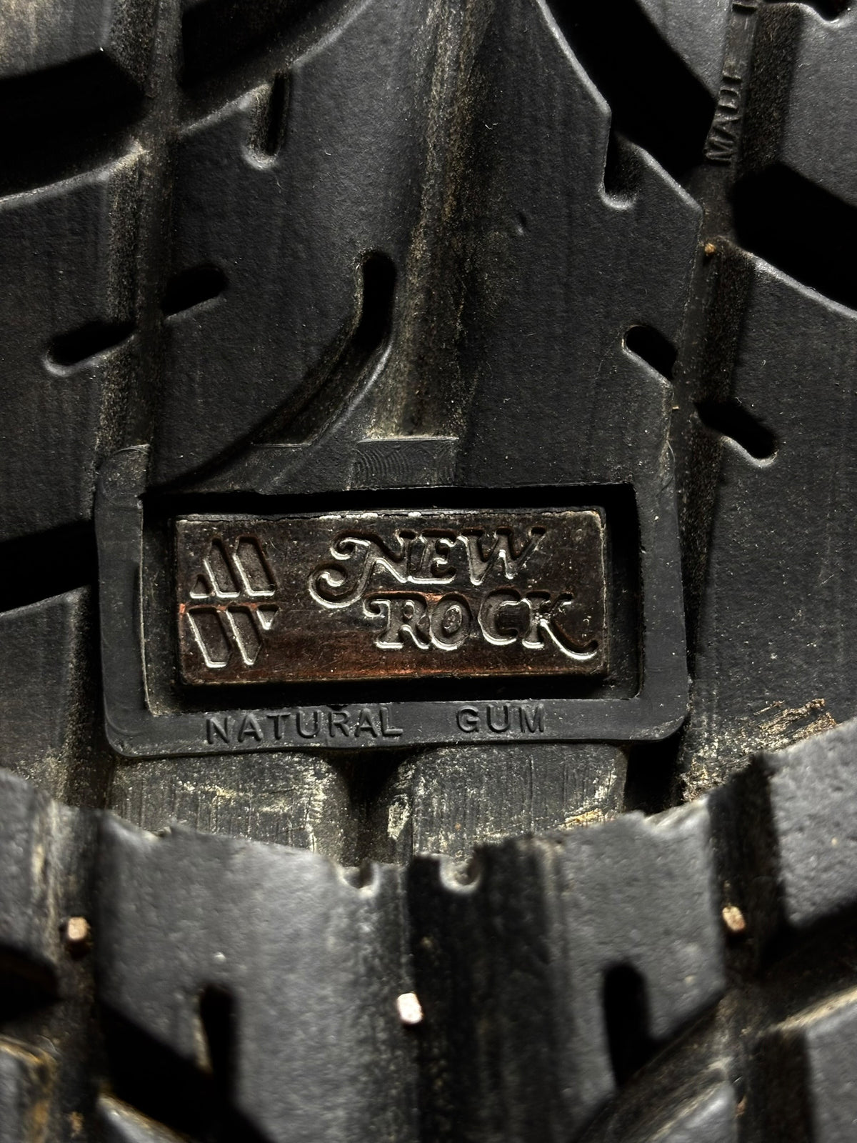 Close-up of boot outsole with New Rock brand plate and rugged tread