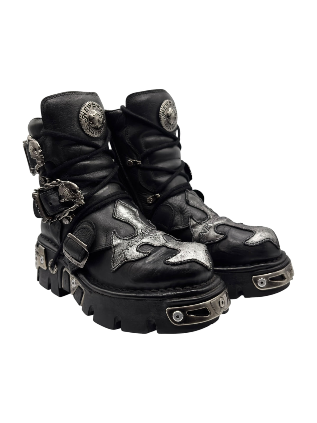 Black lace-up platform boots with silver toe and midfoot patches, chunky outsole, straps