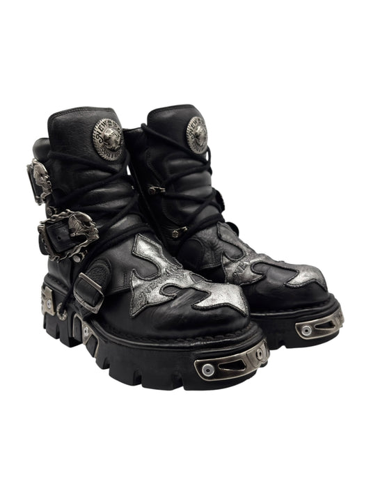 Black lace-up platform boots with silver toe and midfoot patches, chunky outsole, straps