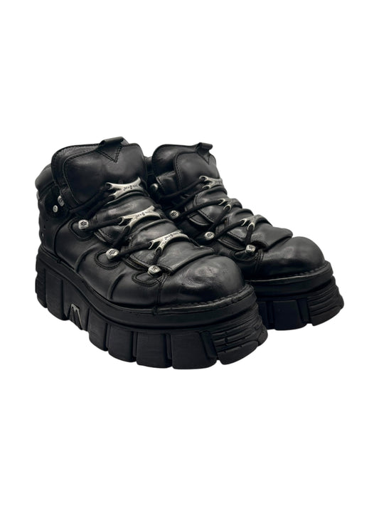 Black lace-up platform boots with stitched panels and chunky lug sole
