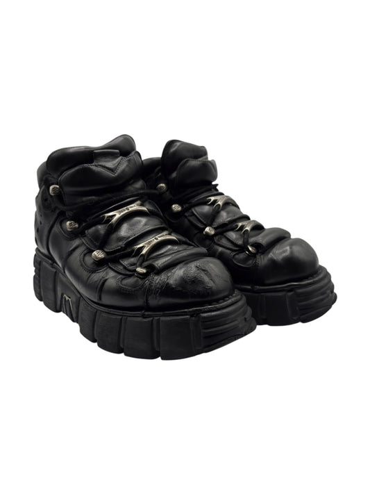 Black lace-up platform boots three-quarter view with thick treaded outsole