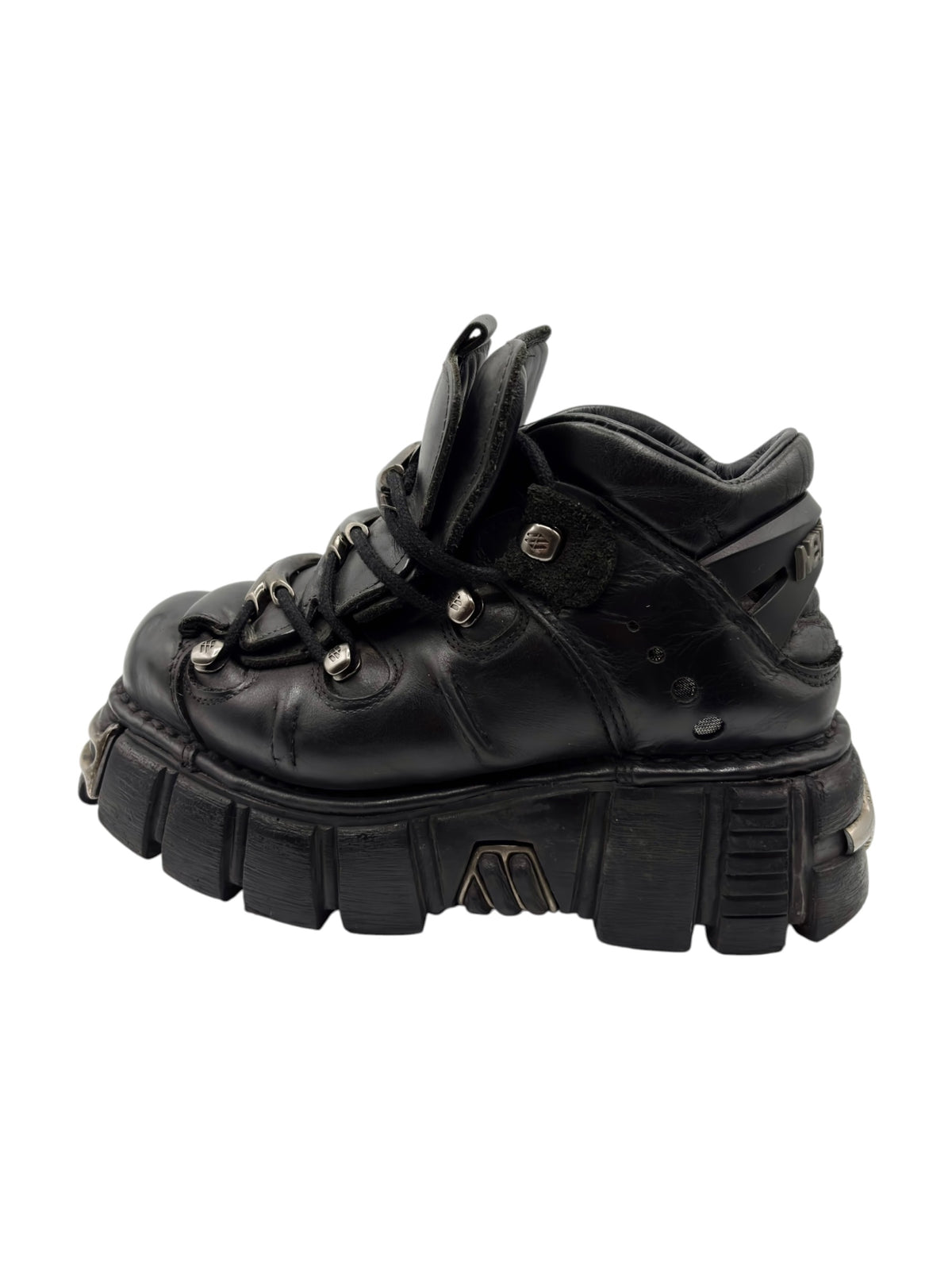 Black lace-up platform boot with buckled strap and stacked rubber sole