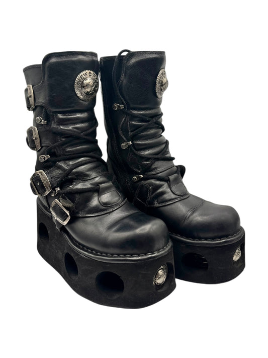 Black mid-calf platform boots with harness buckles and lace-up design
