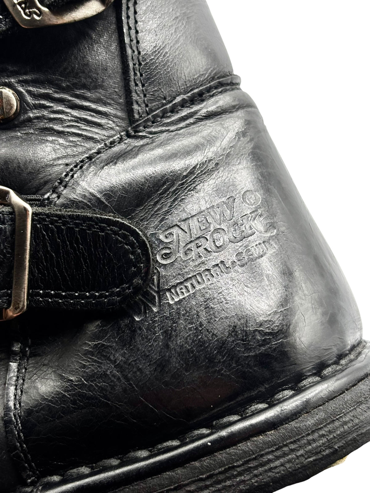 Black leather boot with side buckle strap and “New Rock Natural …” patch