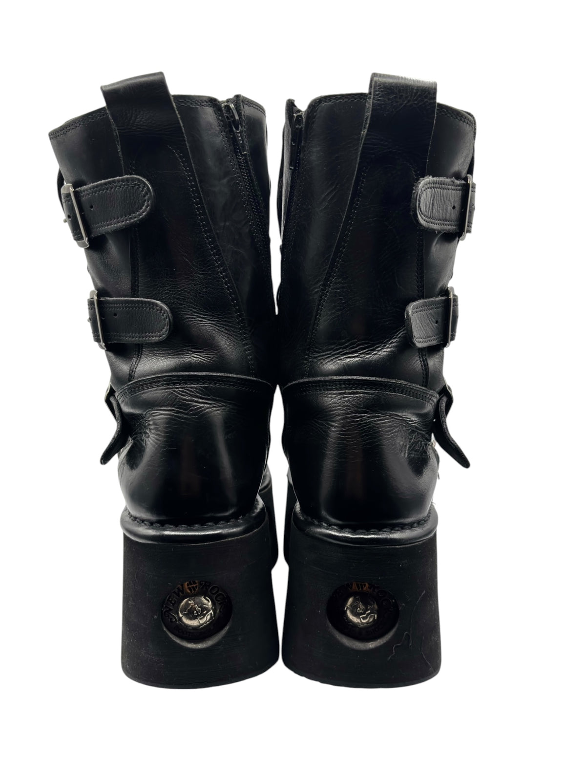 Back view of vintage black platform boots with ankle straps and round hardware