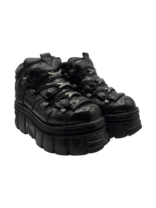 Black lace-up platform boots front three-quarter view with chunky tread soles
