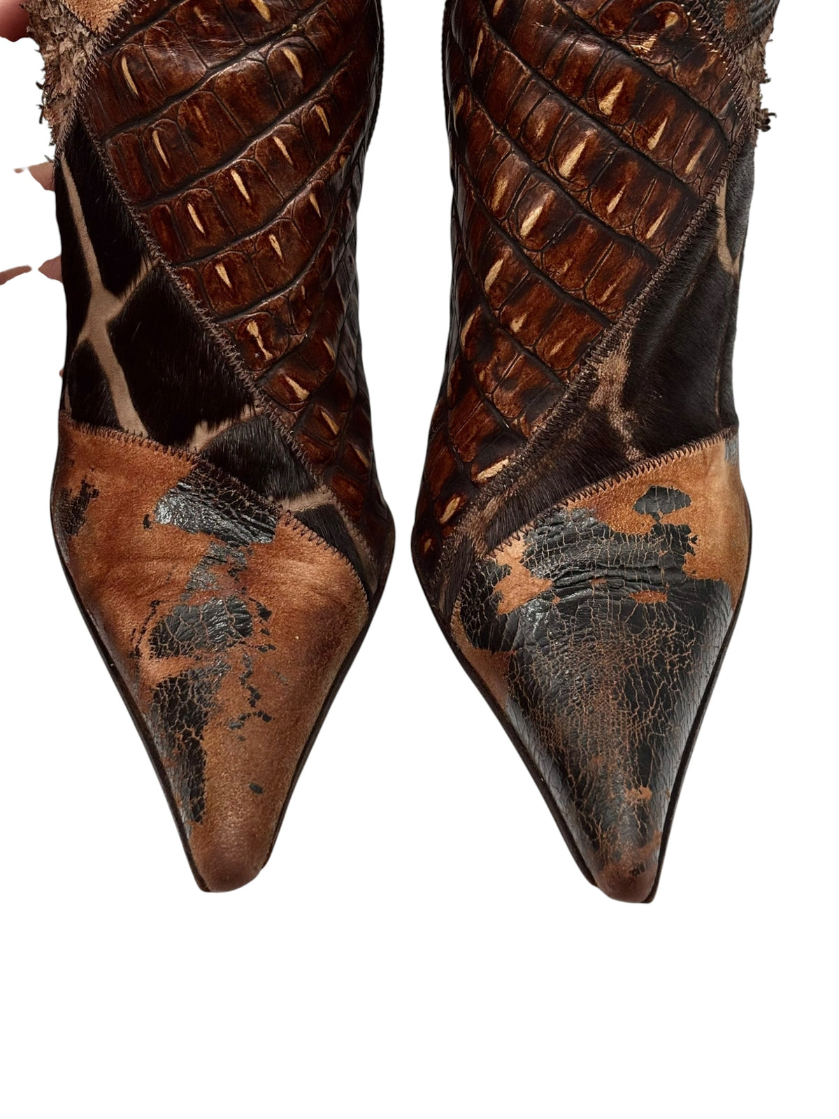 Knee-high patchwork boots close-up of toes, brown leather with speckled cowhide-style pattern